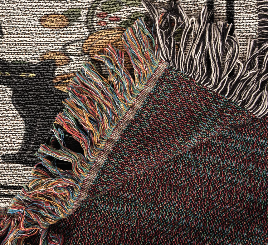 a close-up view of a colorful, textured fabric with fringed edges, showcasing a variety of vibrant colors and patterns.