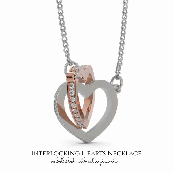 A necklace with a pendant in the shape of a heart, interlocking two smaller heart-shaped pendants. The pendant is made of silver and has a rose gold accent. The necklace is displayed against a white background.